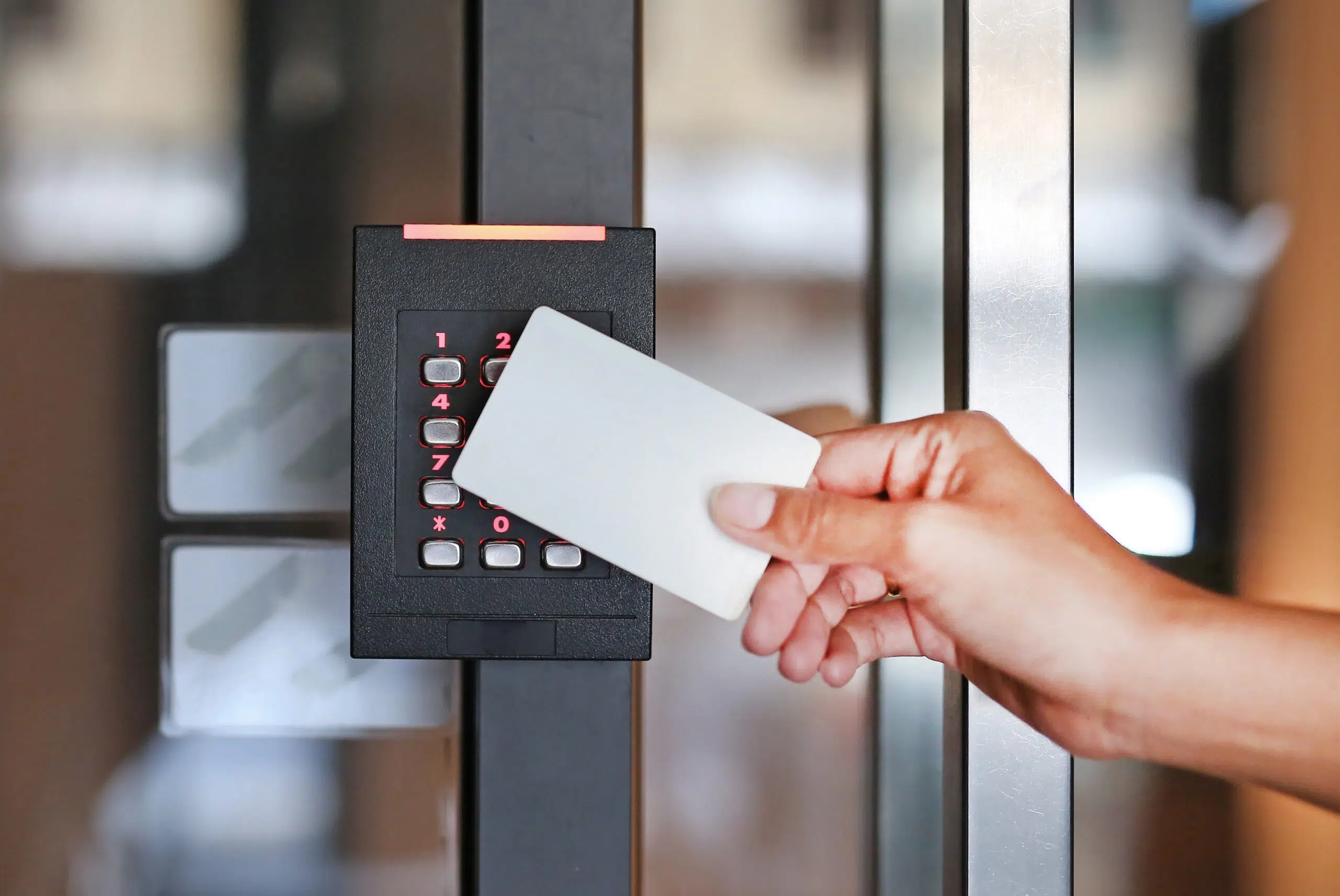 Door access control - person holding a key card to lock